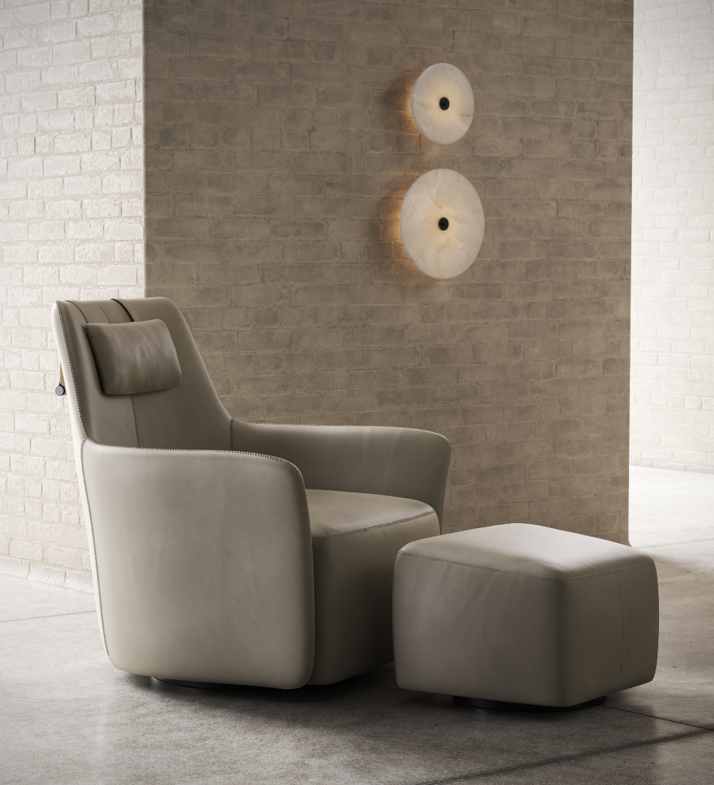 A contemporary armchair and ottoman arrangement in front of a brick wall, emphasising shibiu aesthetics and cosy seating.