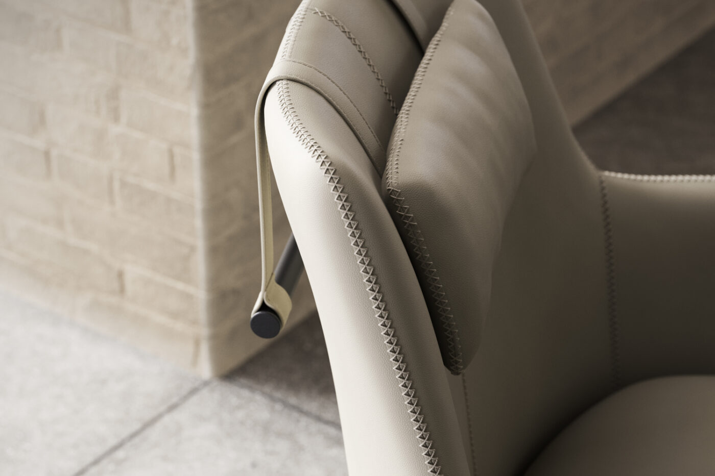 Close-up view of a leather chair featuring a sleek black armrest, highlighting its texture and design details.