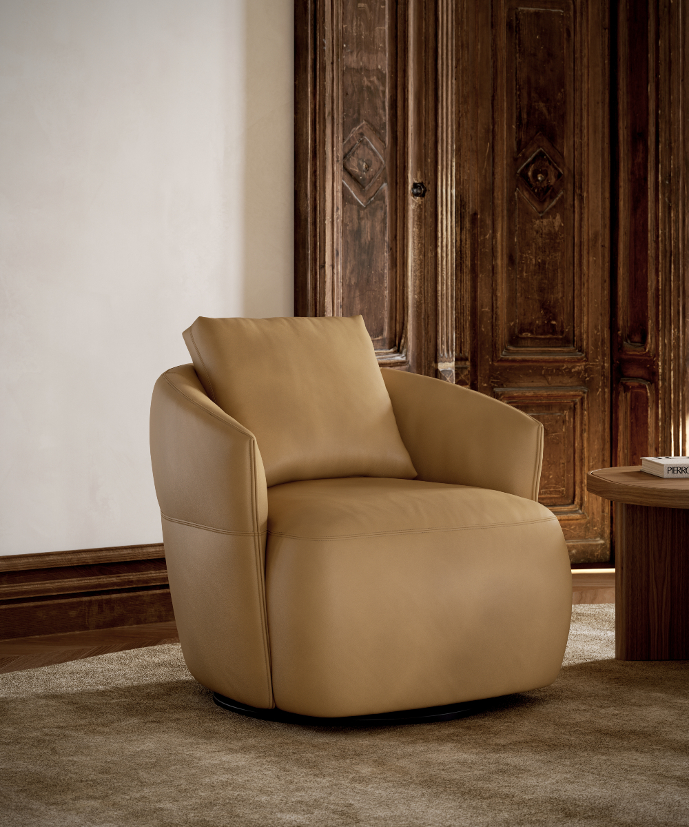 A stylish tan leather armchair is placed in a room with wooden doors, enhancing the room's aesthetic appeal and brown interiors.