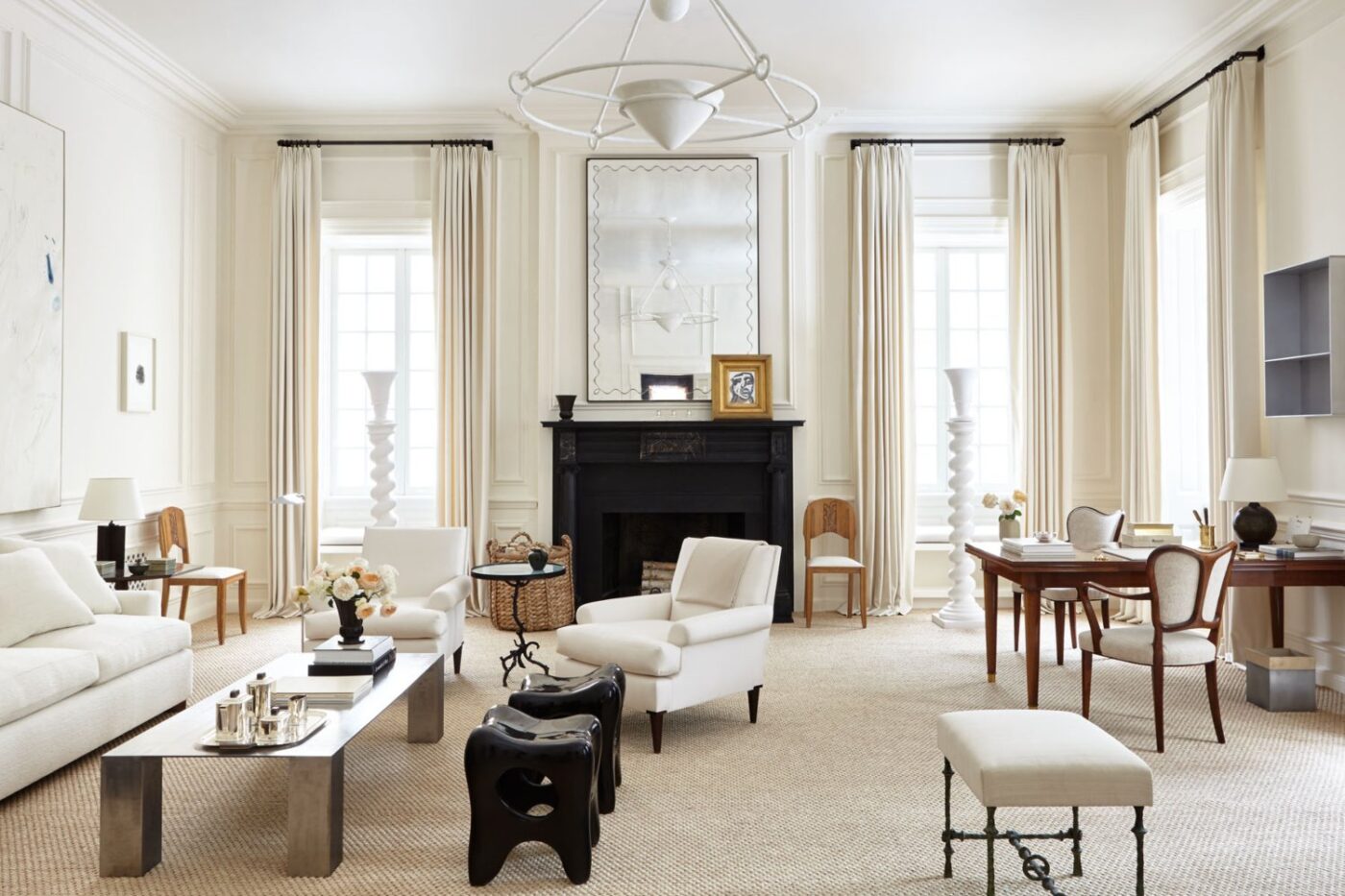 Living room project by Alyssa Kapito with white tones and a black fireplace.