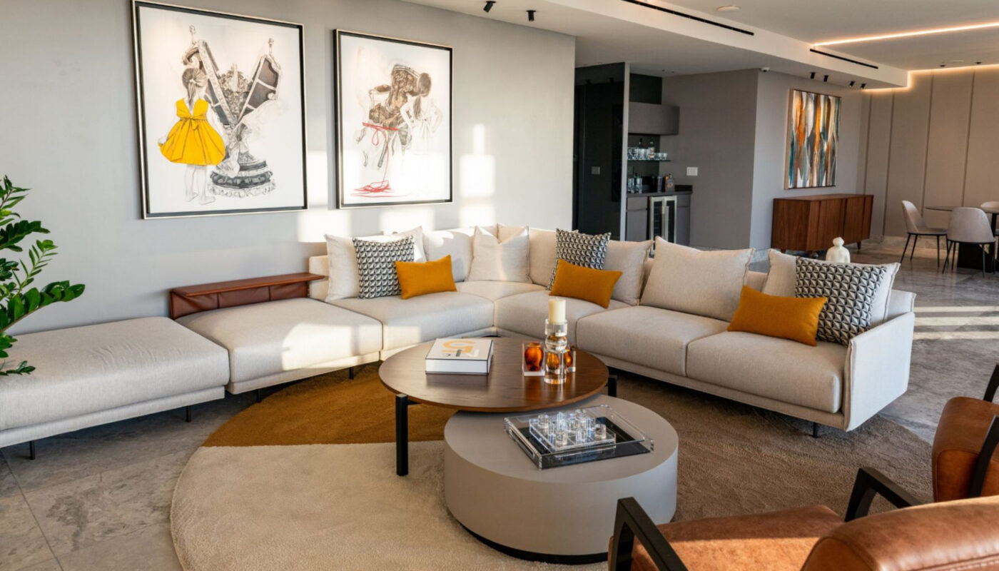 A contemporary living room featuring a spacious sectional sofa, elegantly arranged for comfort and style. From one of the most influential Hispanic interior designers.