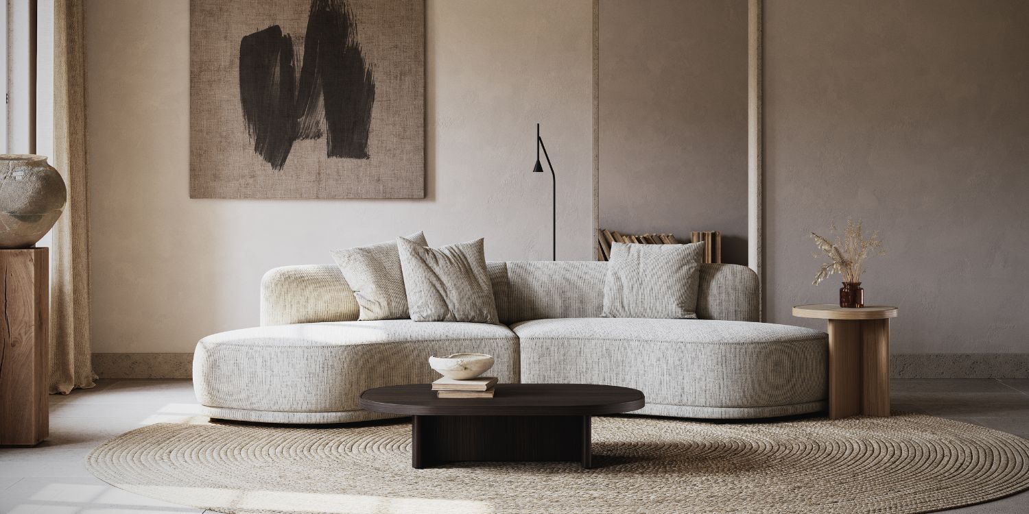 A cosy living room featuring a comfortable couch, a stylish coffee table, and a soft rug on the floor. With a essential piece to match 2025 Interior Design Trends