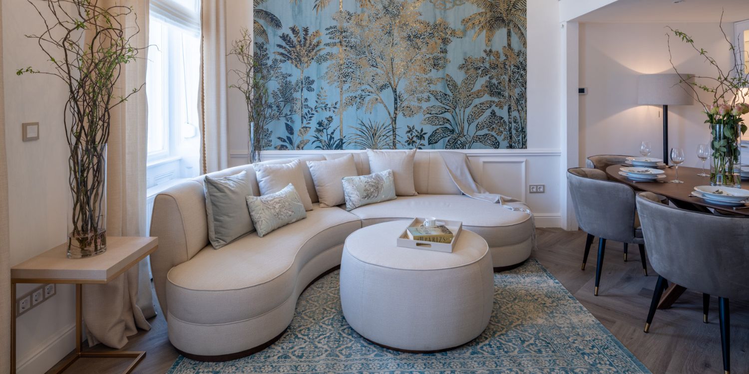 Living room designed by La Fenice with Stella sofa in white and Rachel pouf, also in white, places as a coffee table.