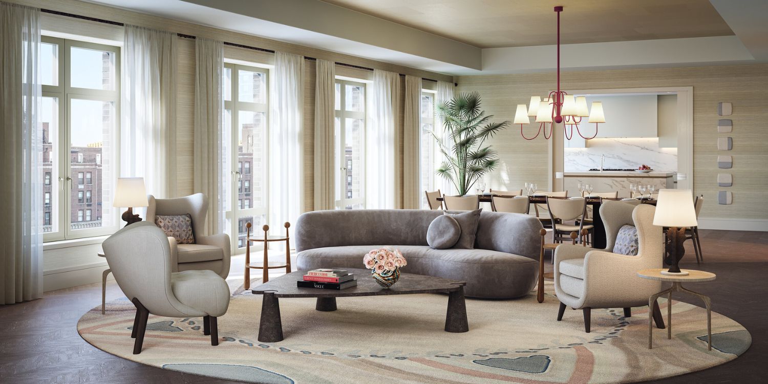 living room with a grey sofa, three white armchairs, one triangular coffee table and a rug with multiple paster colours.