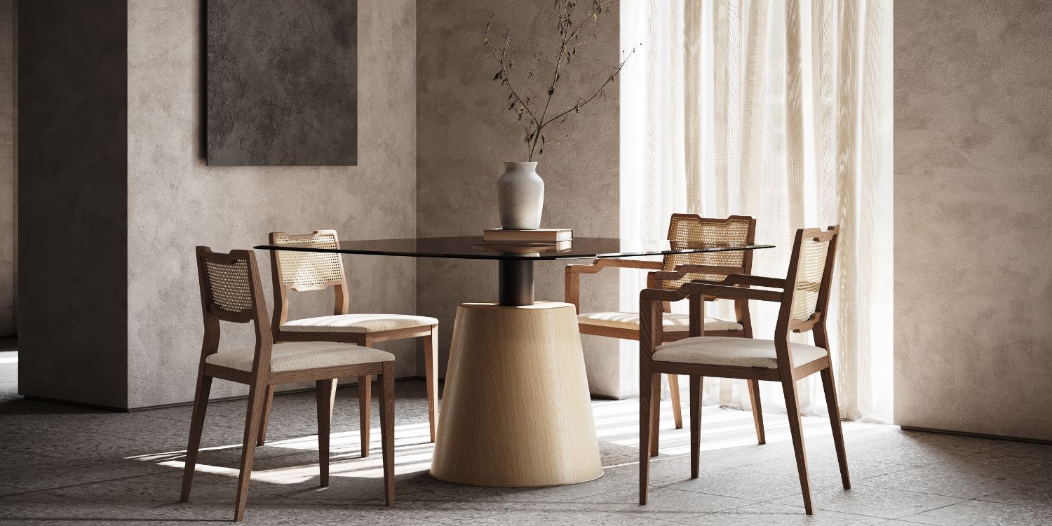 Modern interiors - dining room with four dining chairs in wood and rattan and a dining table in wood and glass. All in neutral tones.