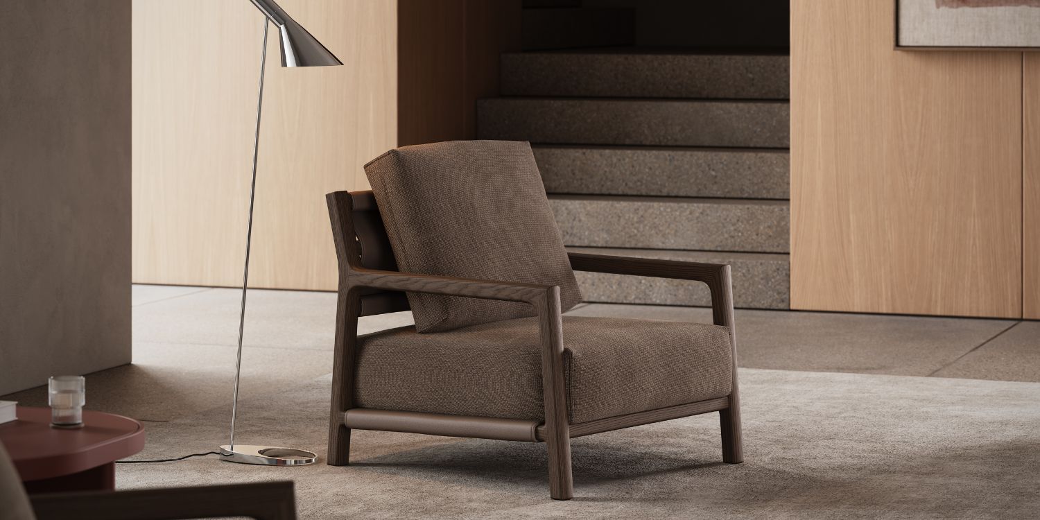 An armchair beside a lamp is situated in a room with a wall, illustrating a minimalist interior design.