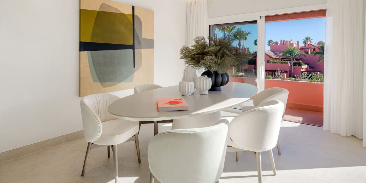 Blog Featured Image - 2026-06-11T151713.771 A well-arranged dining table and dining chairs positioned in a room, showcasing a beautiful view through the window.