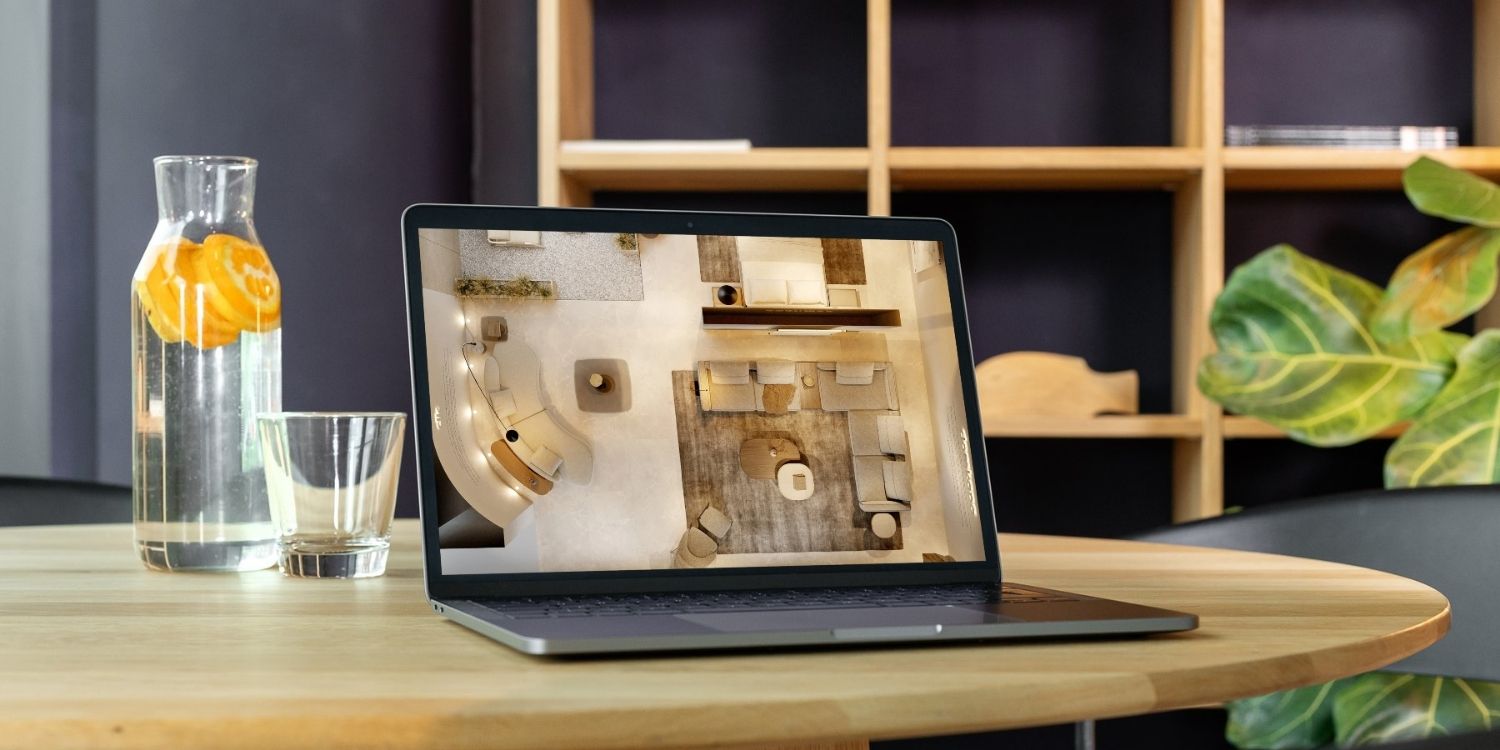 Interior designer reviewing an AI-generated room rendering on a laptop. AI tools for interior designers