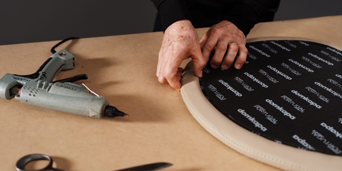 Blog Featured Image - 2026-08-04T152534.707 A person is engaged in chair-making, utilizing a glue machine to secure components together in a workshop environment.