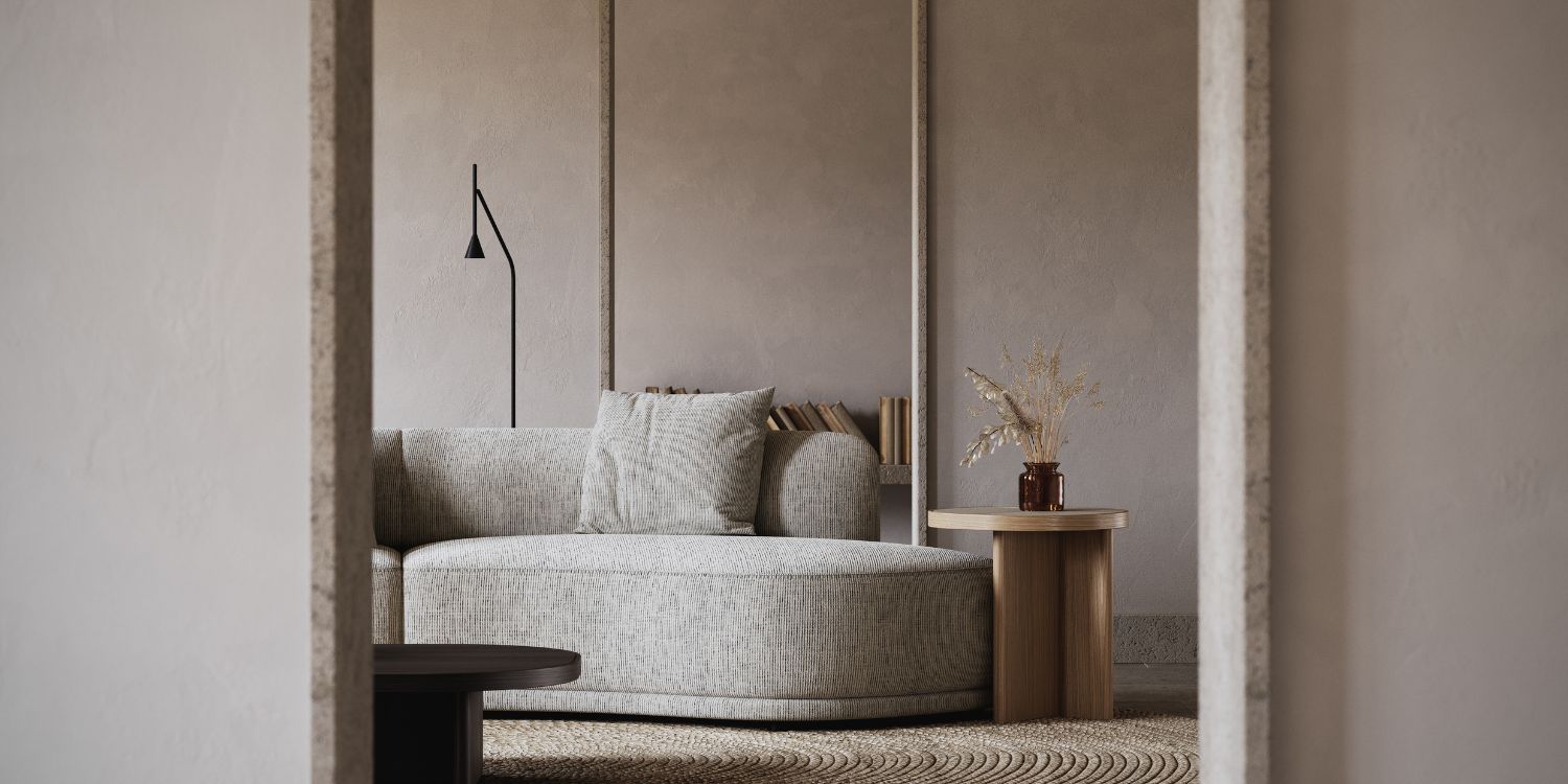 A cosy living room featuring a modular sofa and side table, with a door where you can see through to the inviting space. It reflects the danish interior design.