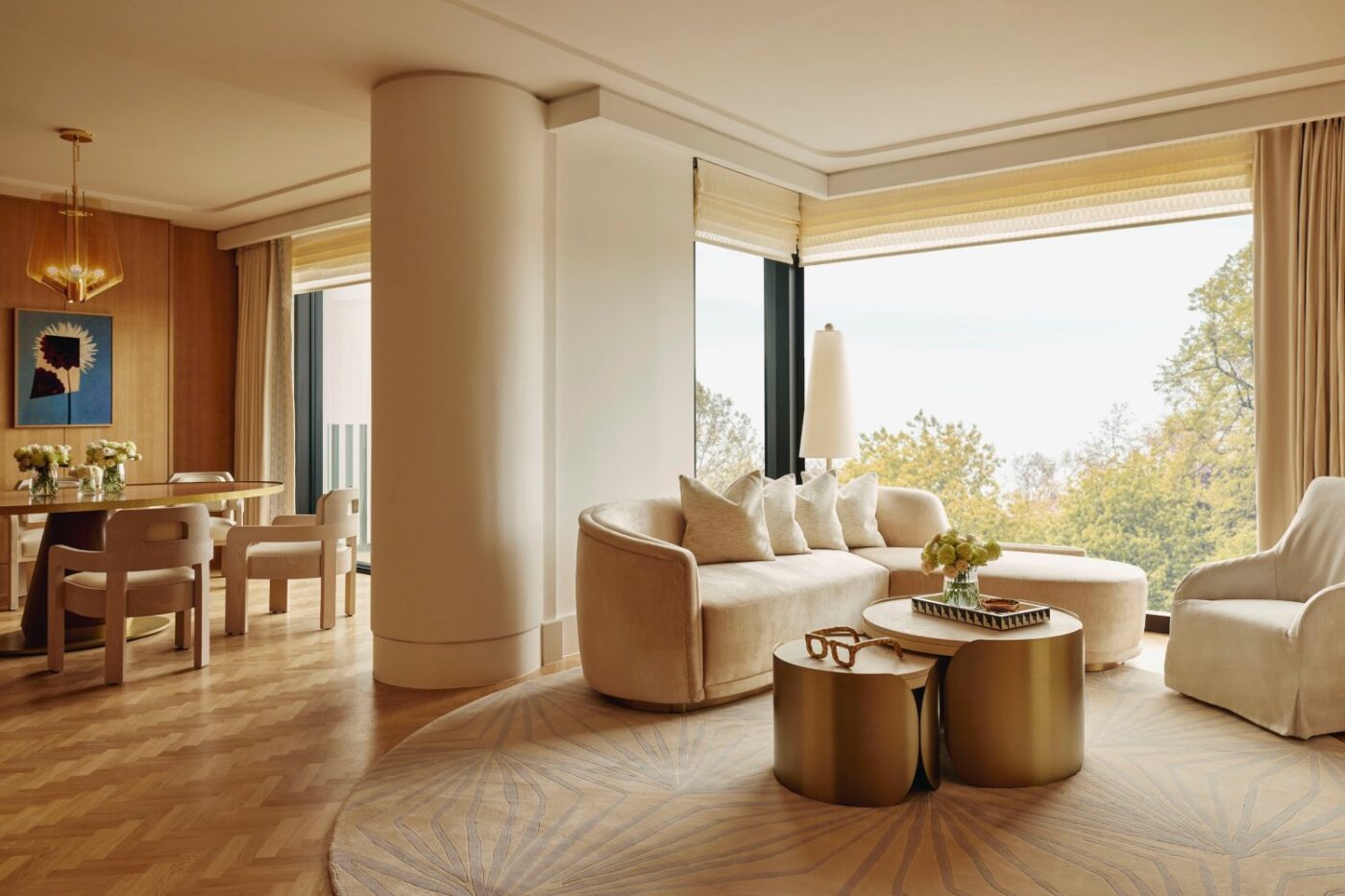 Living room design by Champalimaud Design with beige tones and gold accents in the coffee tables.