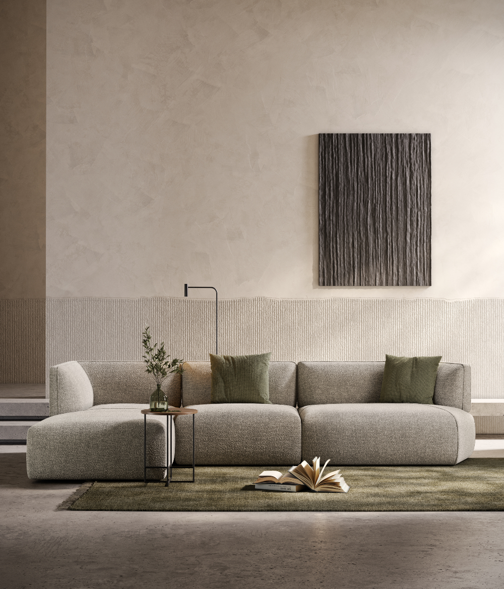 Modern living room with a textured silver modular sofa, abstract wall art and minimalist decor.