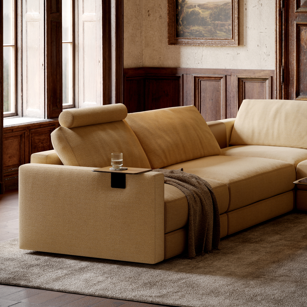 A modern modular sofa with ample seating space, designed for comfort and elegance in a living area. With an armrest tray in metal and leather.