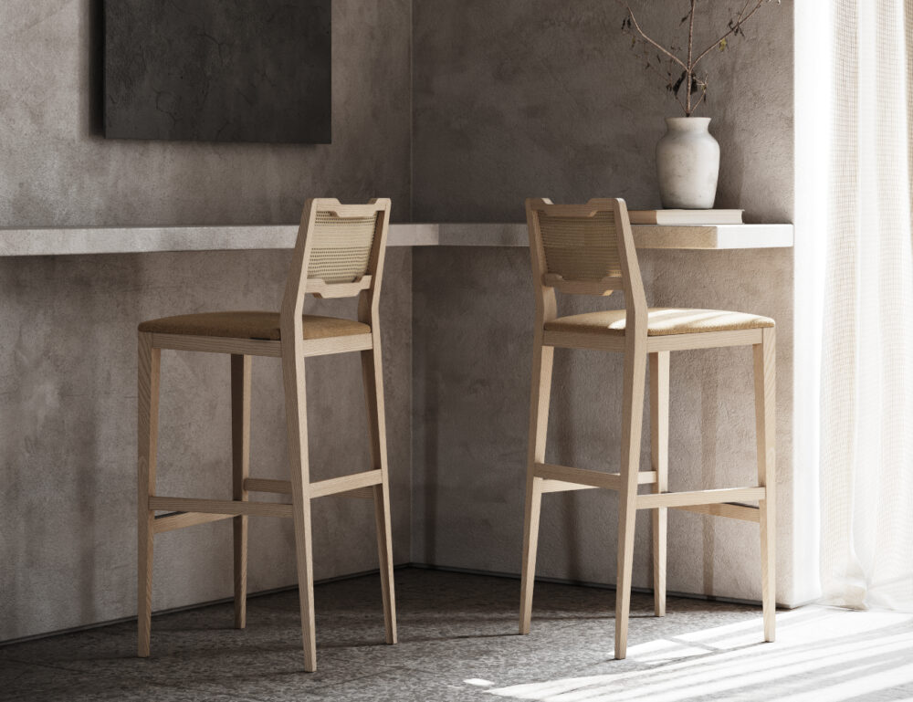 Bar and counter chairs in light wood and rattan on the backs. The seat is upholstered in fabric.