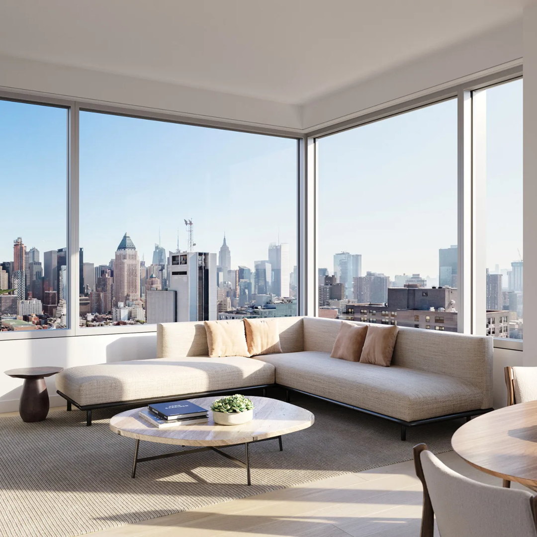 Living room in a penthouse with white tones. With a neutral toned sofa and a coffee table in marble.