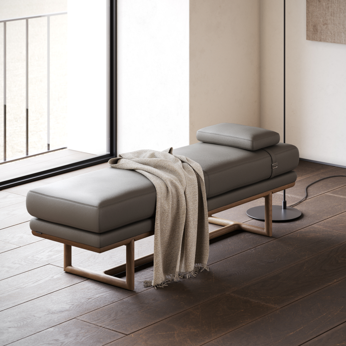 A comfortable bench topped with a blanket, situated on a beautiful wooden floor.