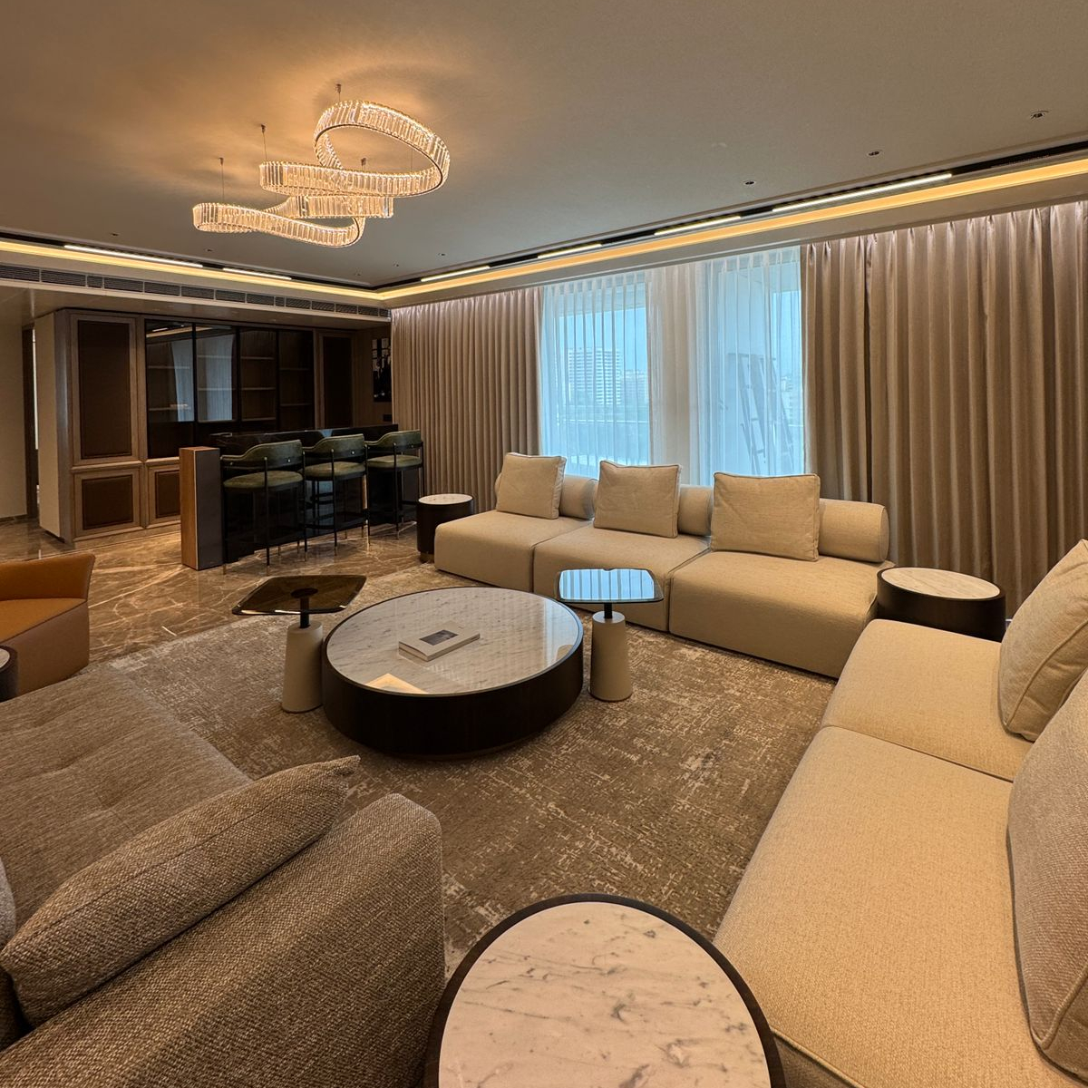 A stylish living room with comfortable modular sofa arranged around a coffee table, inviting relaxation and conversation.