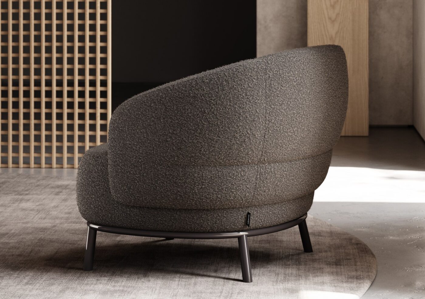 A gray armchair located in a room with a rustic wooden wall, offering a stylish and comfortable seating option.