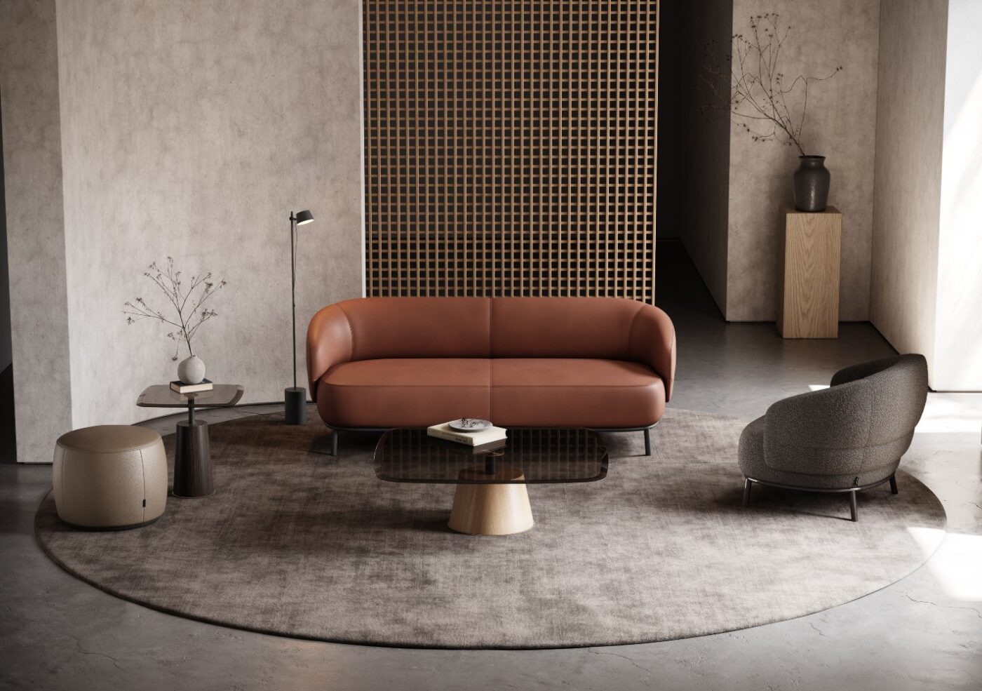 A contemporary living room featuring a round sofa, an armchair and pouf, creating a cosy and inviting atmosphere.