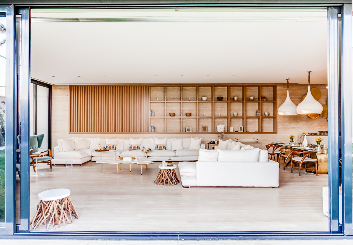 Living room project with a white sofa and wood accents in the coffee tables. With beach vibes.