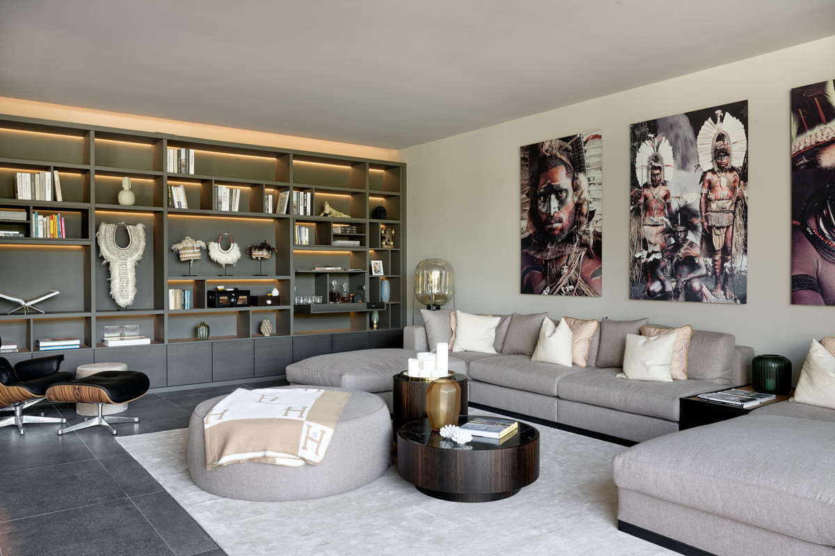 A contemporary living room featuring a stylish sofa, a sleek coffee table, and a comfortable armchair, creating a cosy atmosphere.