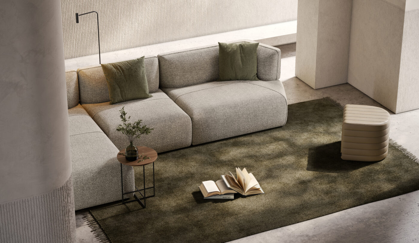 A Shibui living room showcasing a comfortable modular sofa, a neutral pouf and a lamp that enhances the ambiance. With muted green tones.