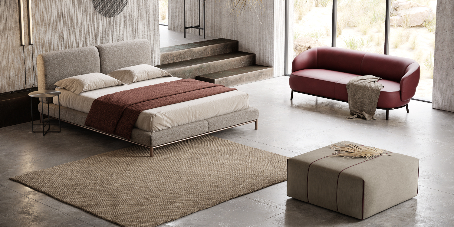 A contemporary bedroom featuring a stylish bed, a comfortable sofa and a matching pouf for relaxation. From the 2022 collection.