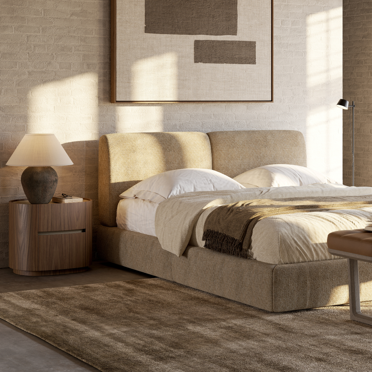 A comfortable bed in soft materials surrounded by inviting bedroom decor.