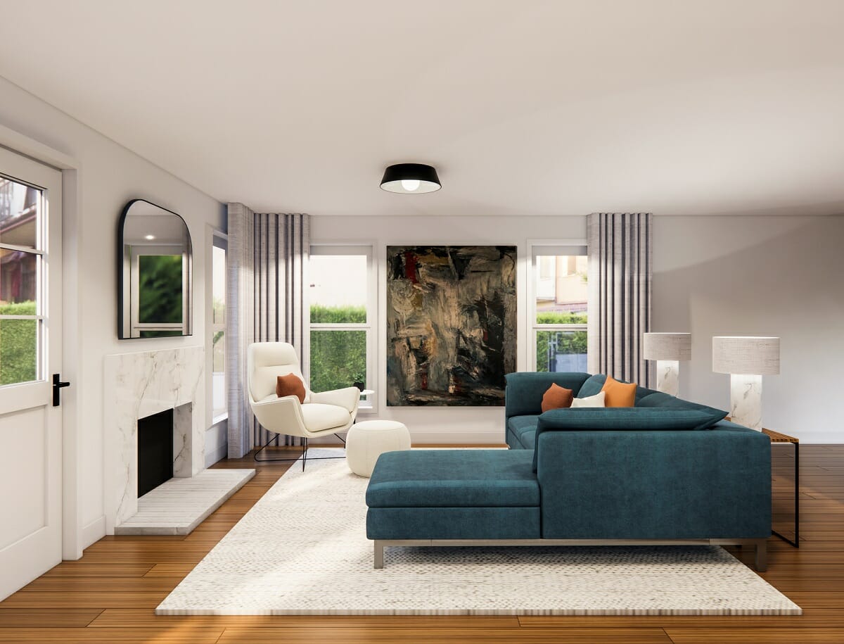 How to apply the Bagua: living room with a blue living room in front of a fireplace and a mirror. With a white rug on the floor and a white armchair and pouf.