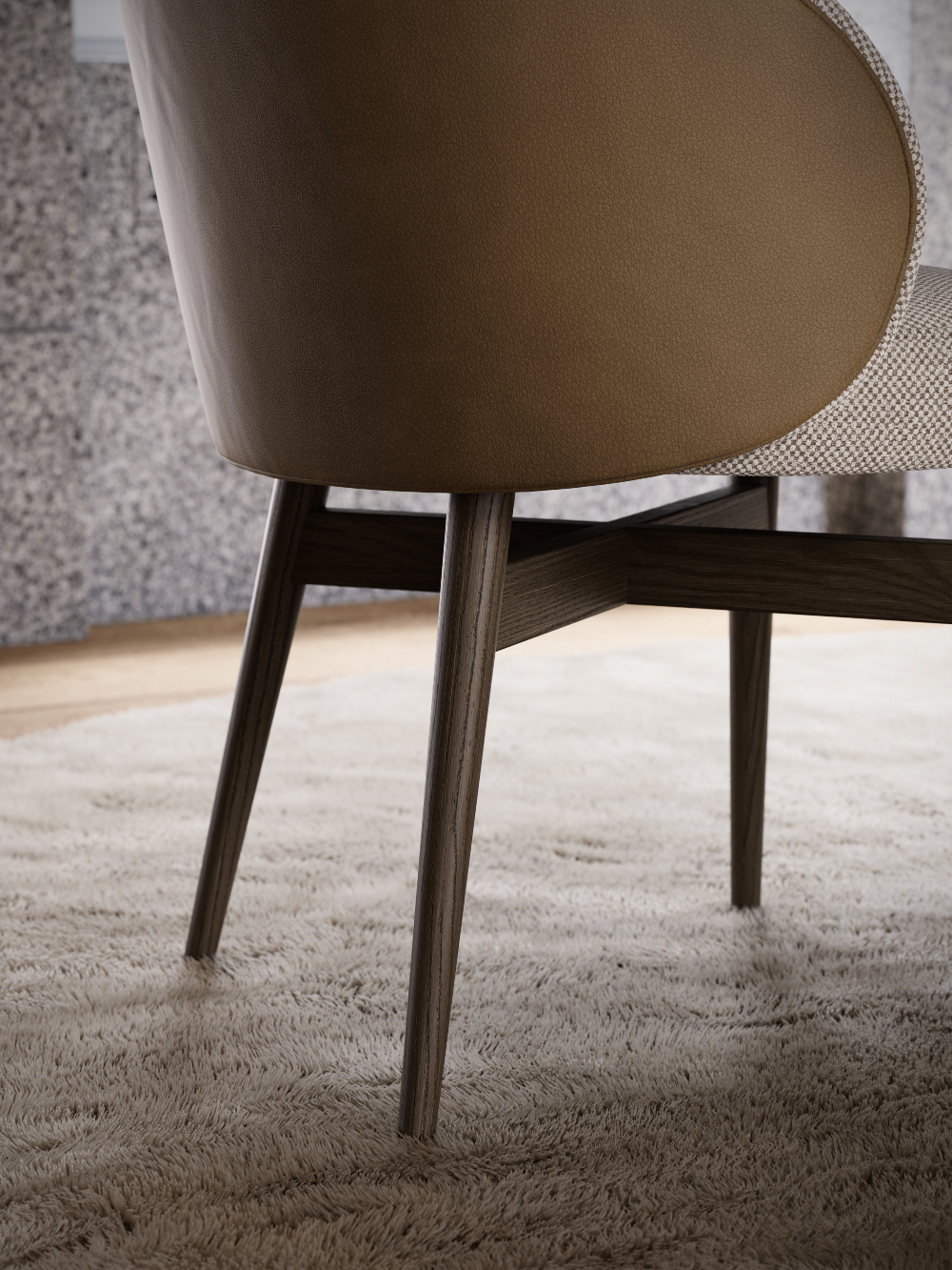 Back of a dining chair upholstered in light brown leather and with four wooden legs.