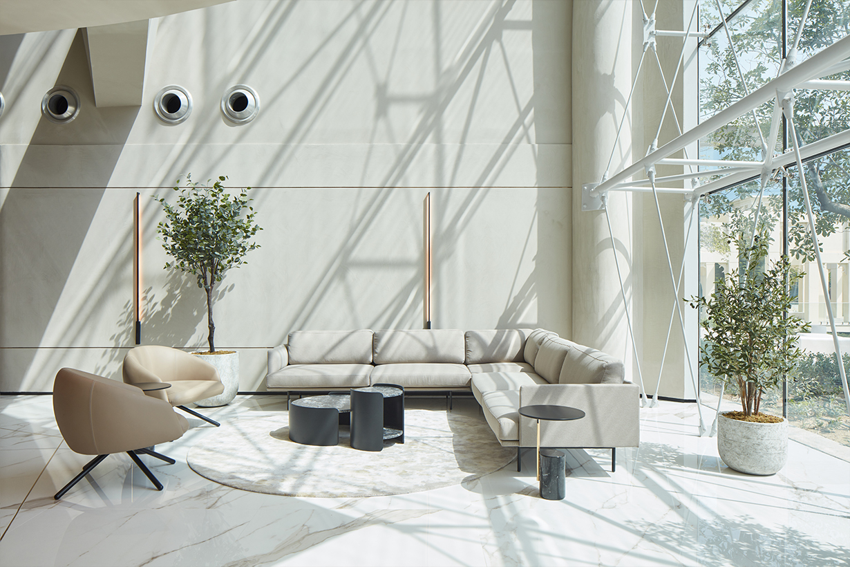 Bright living room with a large window, showcasing a cosy couch for relaxation. By the Roar, a firm from the middle east.