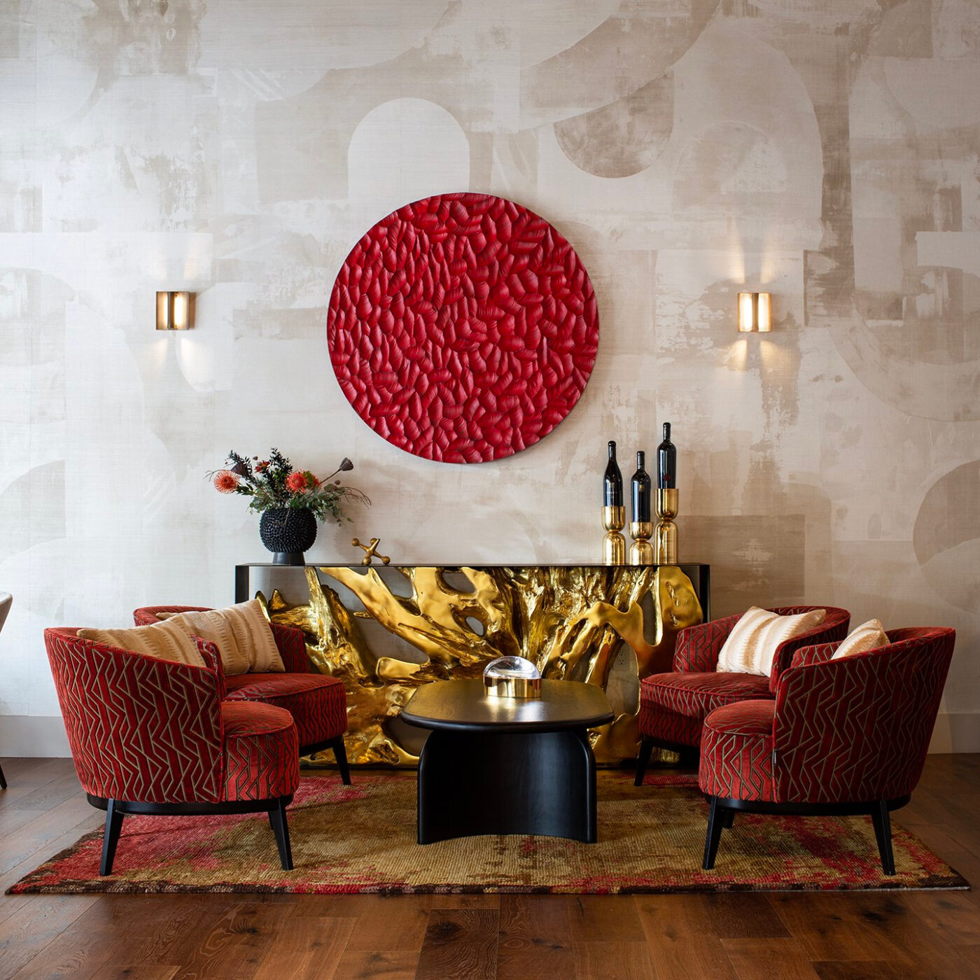 modern interior with four armchairs in a red fabric with gold accents.