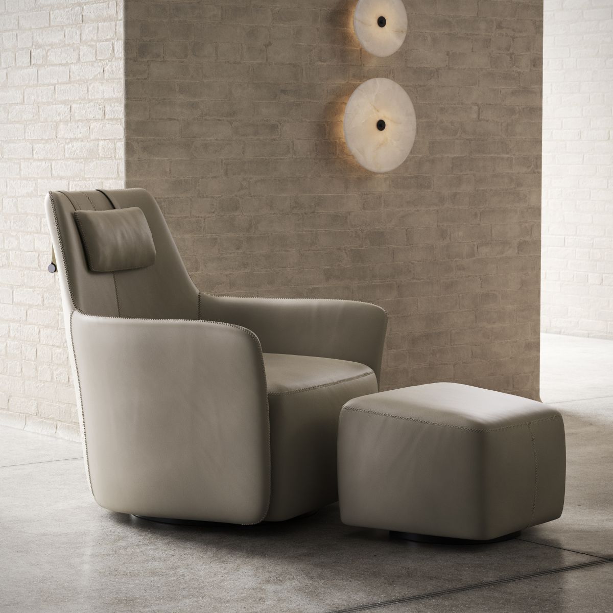 Specifying Upholstery For Hotel Suites (5) A modern beige armchair with a matching ottoman sits on a concrete floor against a brick wall. Two round wall lights provide ambient lighting.