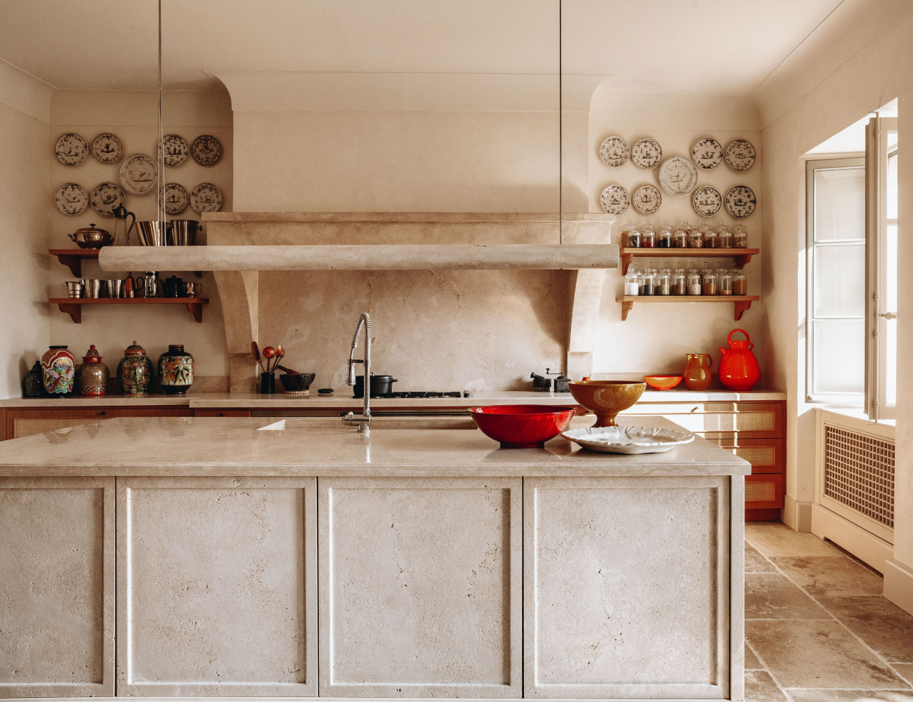 A modern kitchen showcasing a clean sink and a stylish countertop, ideal for culinary activities. The counter is in travertine, one of the trending materials for 2025.