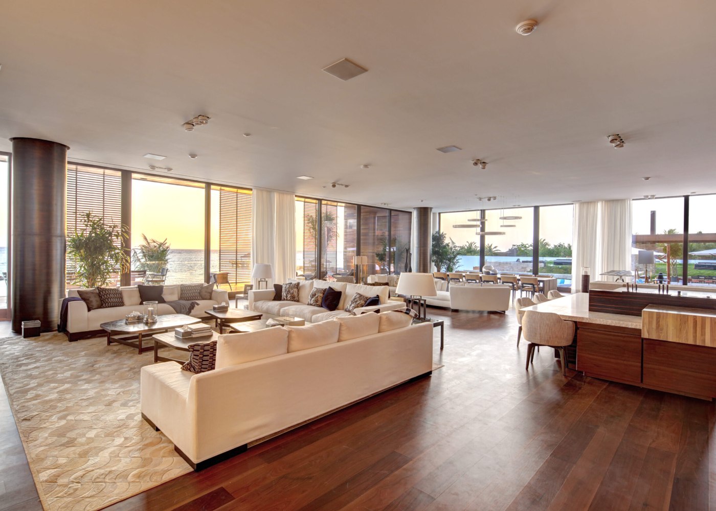 A bright living room with a large window providing a picturesque view of the tranquil water beyond.