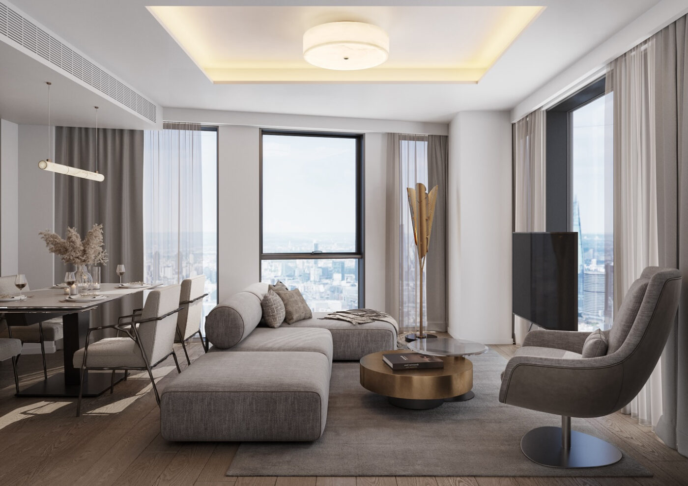 A modern living room with a city view features a gray sectional sofa, a round coffee table, and a sleek armchair. Floor-to-ceiling windows let in natural light, and a dining area with a table and chairs is visible on the left. By one of the most Influential Interior Designers In The UK