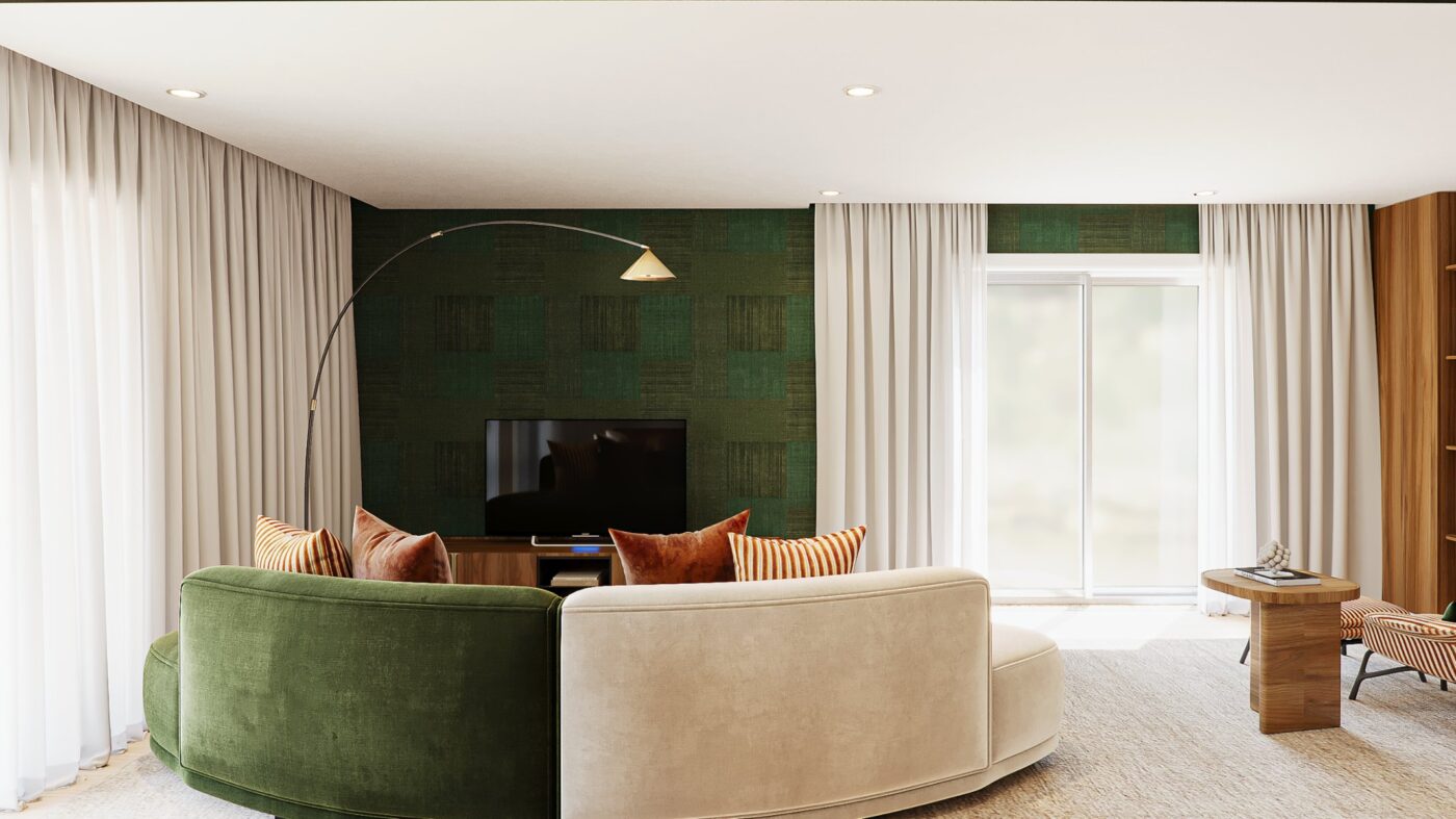 Living room with modular sofa. This view is from behind and it can be seen the behind of the sofa and its two colours: green and beige. The walls are in a green mathing the sofa. There is a side table in wood and a window.