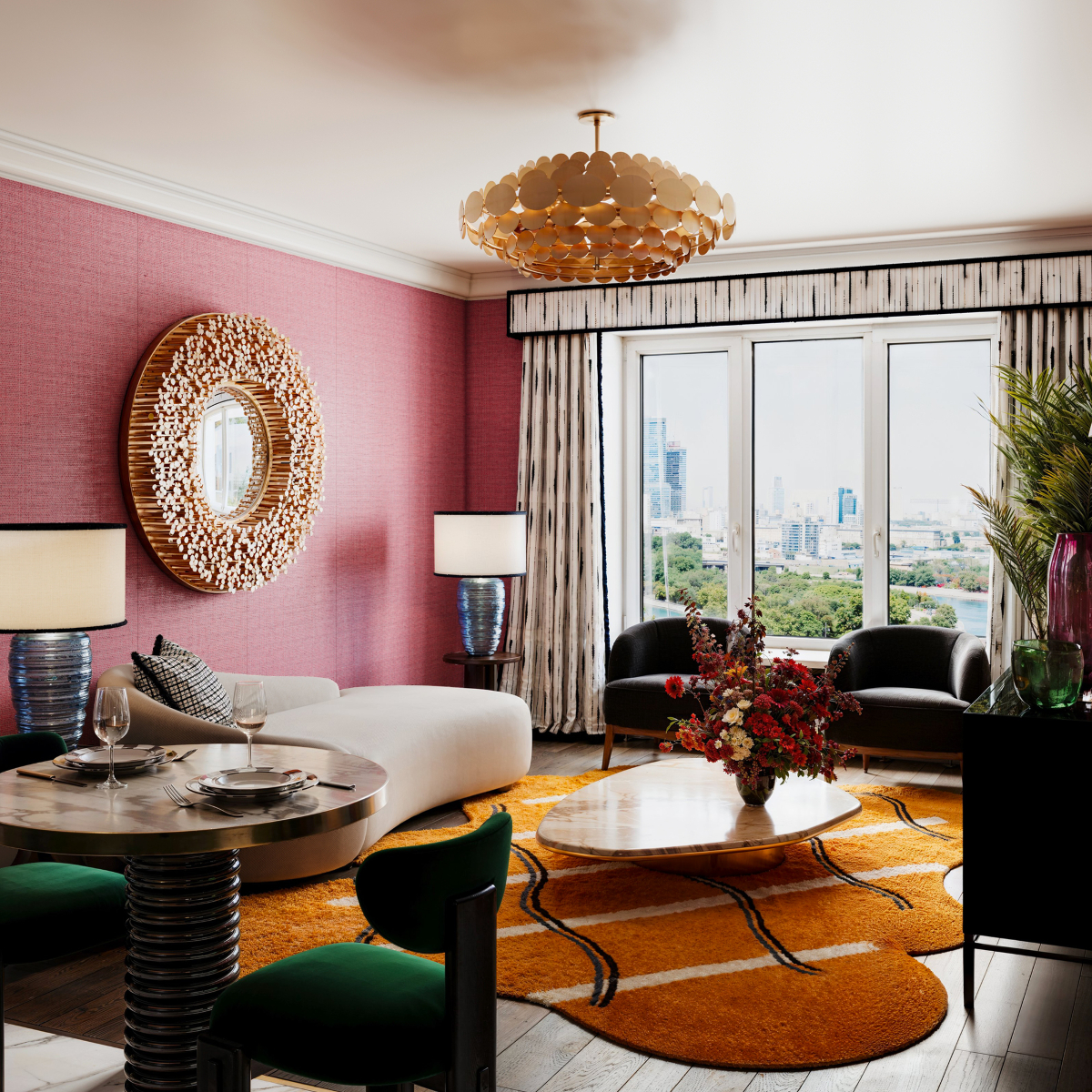 Design Stories: A spacious living room featuring a coffee table surrounded by armchairs and a sofa.