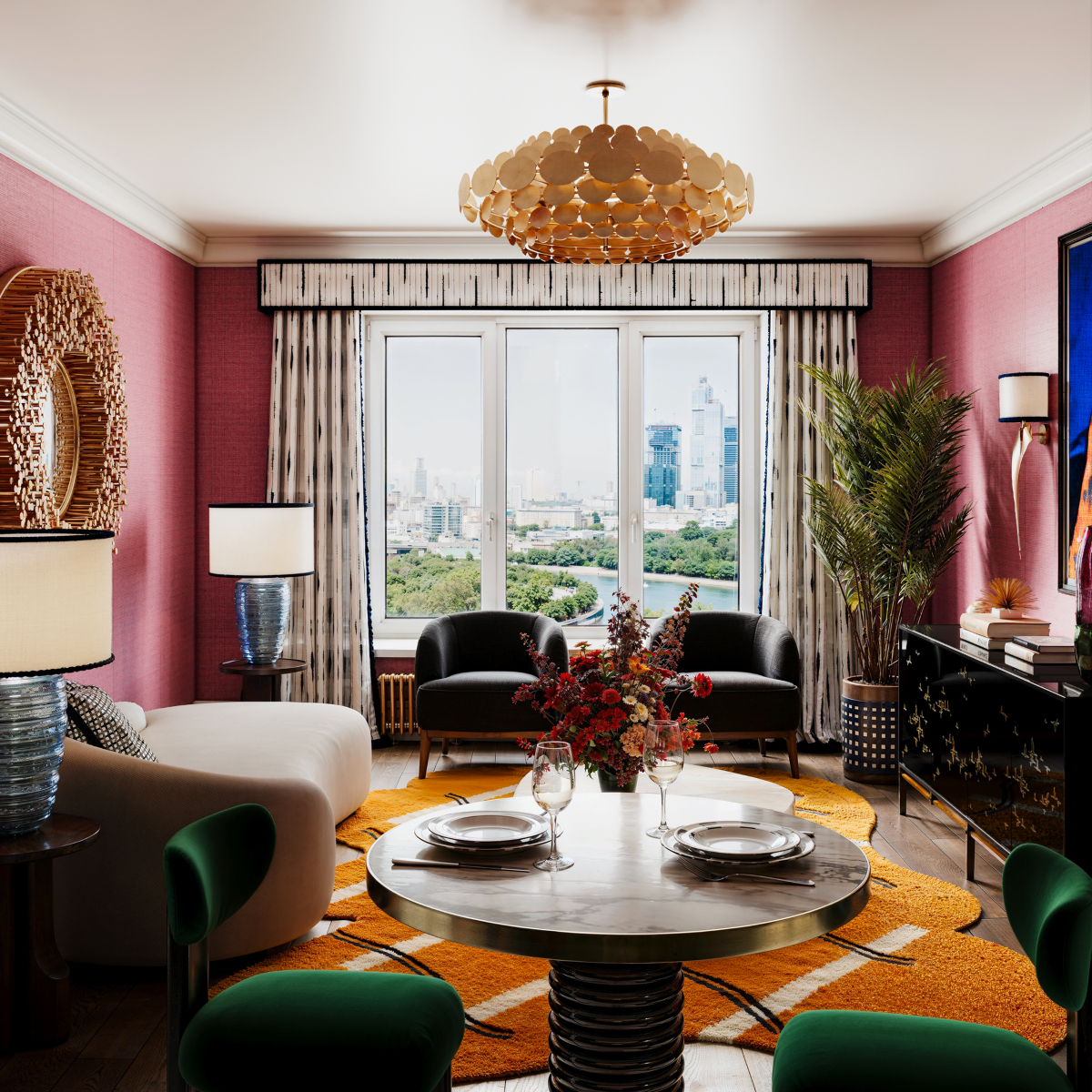 Design Stories: A bright living room showcasing a large coffee table with armchairs set around it.