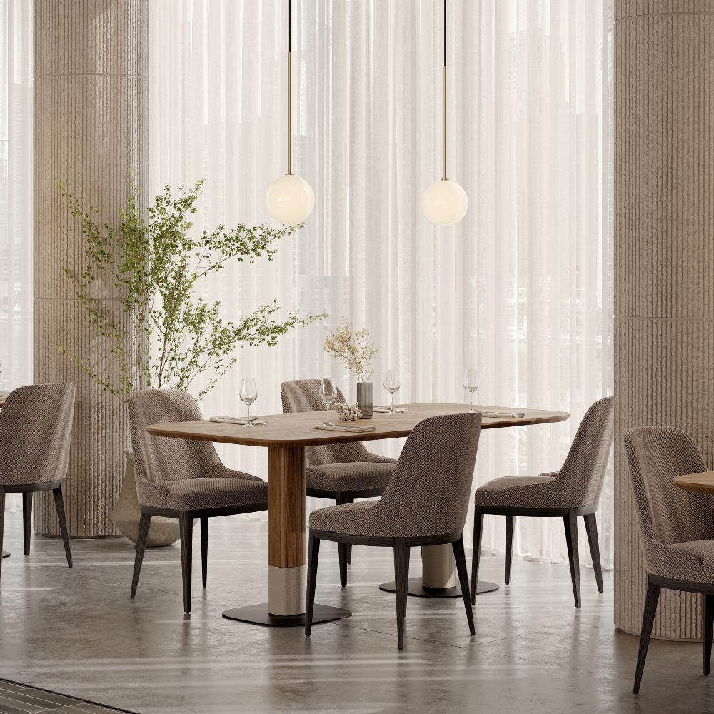 adam tables for blog article hybrid living Inside a restaurant, a table and chairs are arranged by a window, creating a cosy dining atmosphere.