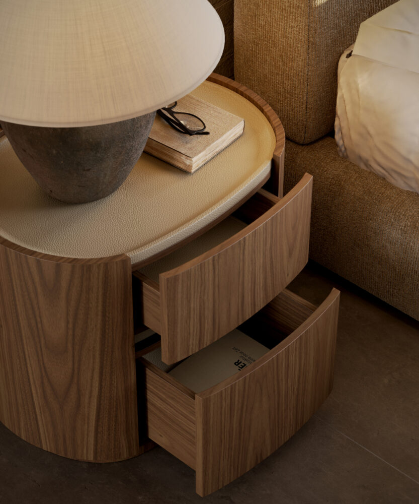 A wooden bedside table featuring drawers and a lamp, ideal for nighttime reading and storage. Bedroom essentials.