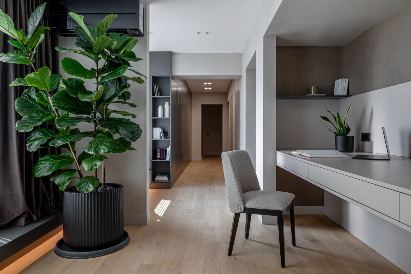A stylish modern bedroom with a green plant in the corner, enhancing the room's aesthetic and promoting a calming vibe.