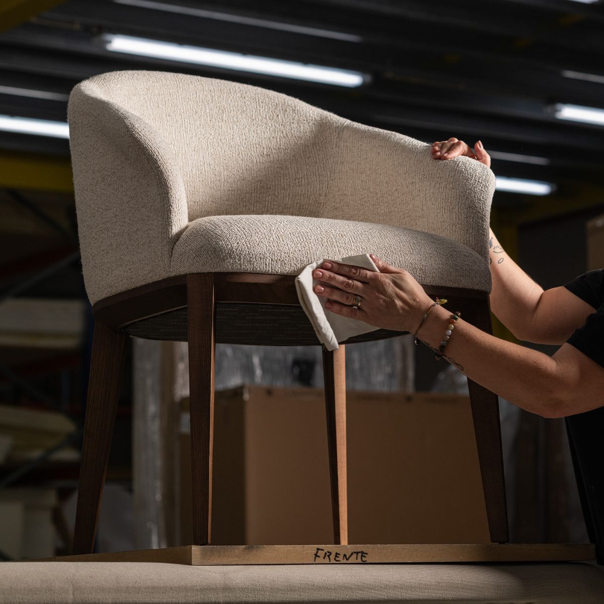 blog article about care & maintenance (1) A woman is using a white cloth to clean a chair, focusing on maintaining its cleanliness and appearance. Care & maintenance guide