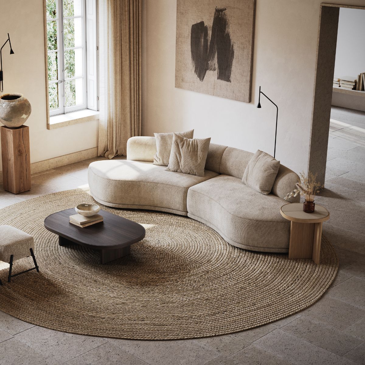 blog article about midiminimalism (2) Living room with a curved sofa upholstered in a neutral fabric, a table set in wood and a round textured rug.