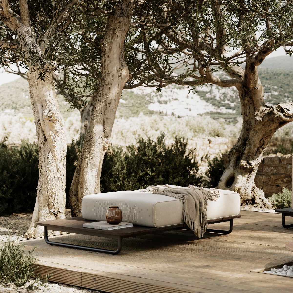 blog article about outdoor upholstery by domkapa (3) A wooden deck with a simple pouf and a tree nearby, providing a peaceful setting for relaxation.