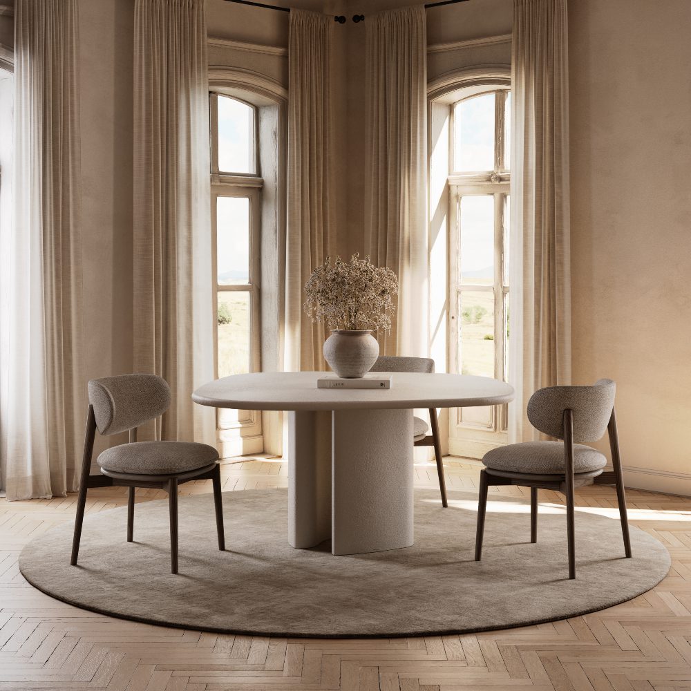 blog article by domkapa about hybrid living A round table set with chairs around it, showcasing a vase in the middle.