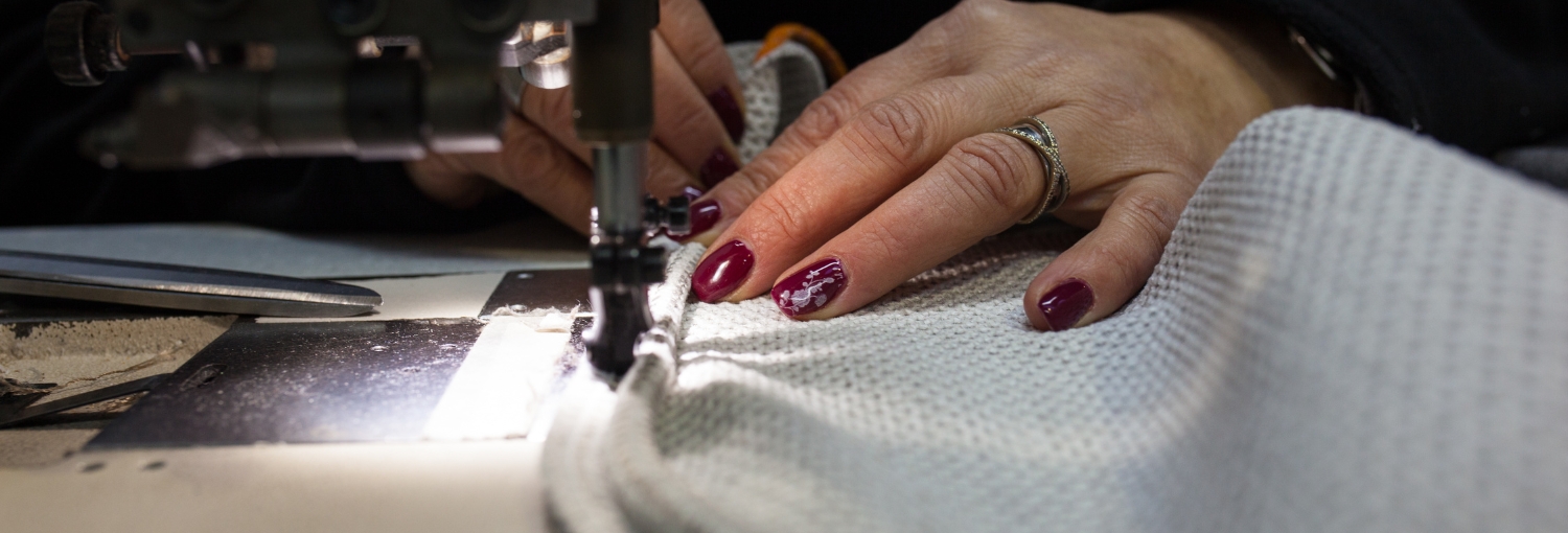 Seamstress sewing fabric