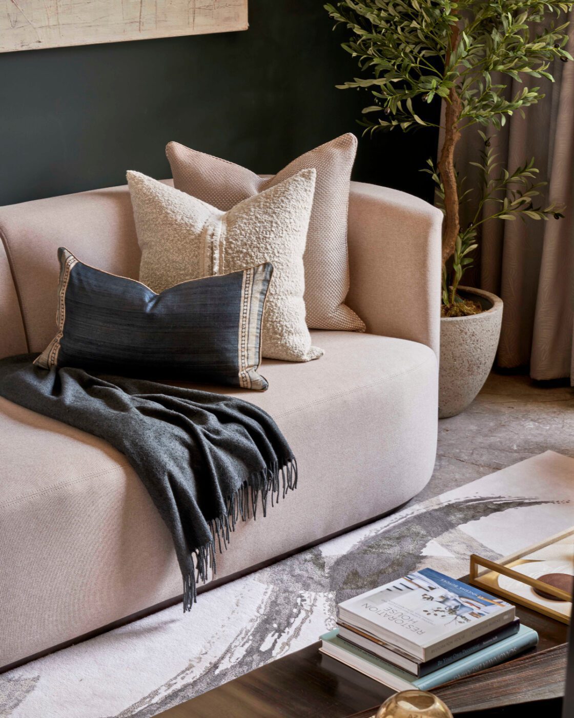 chloe sofa in the stylish friend project An inviting living room with a plush sofa, a stylish coffee table, and a large bookshelf filled with various books. Project by The Stylish Friend