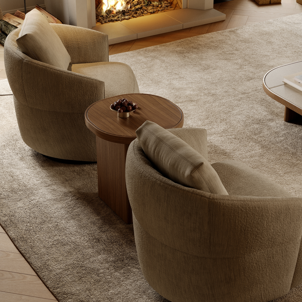A warm living room scene with a fireplace and two inviting chairs positioned nearby. Café core
