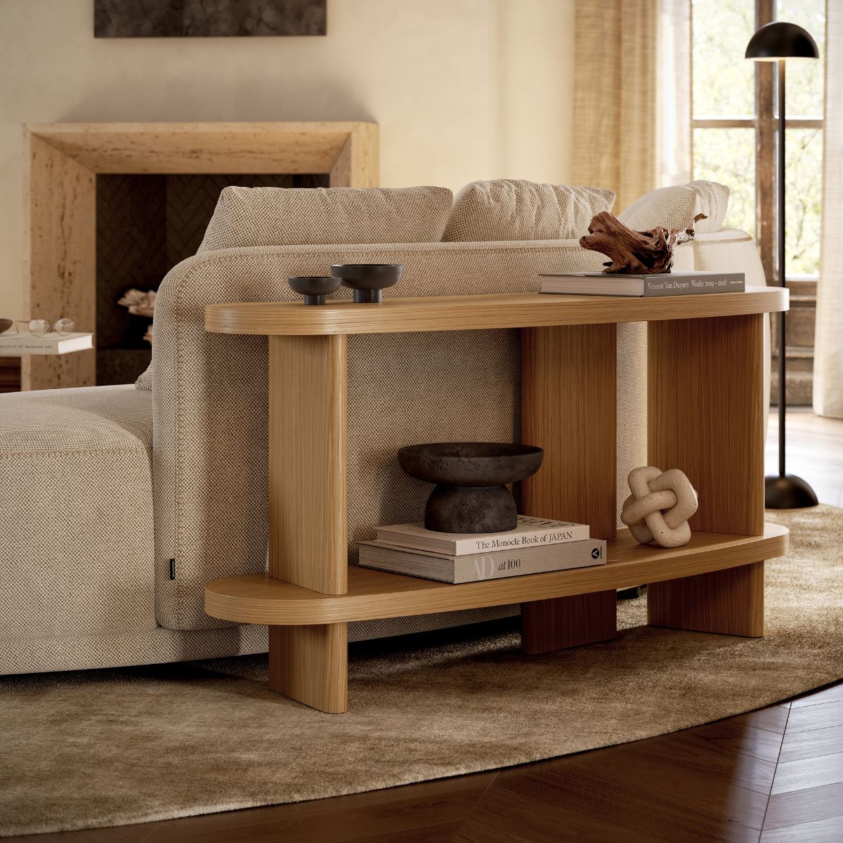 danish interior design (1) Cosy living room scene with a beige sofa against a wooden console table. Decor items include books, a black bowl, and a knot sculpture, creating a warm, inviting atmosphere. Danish interior design